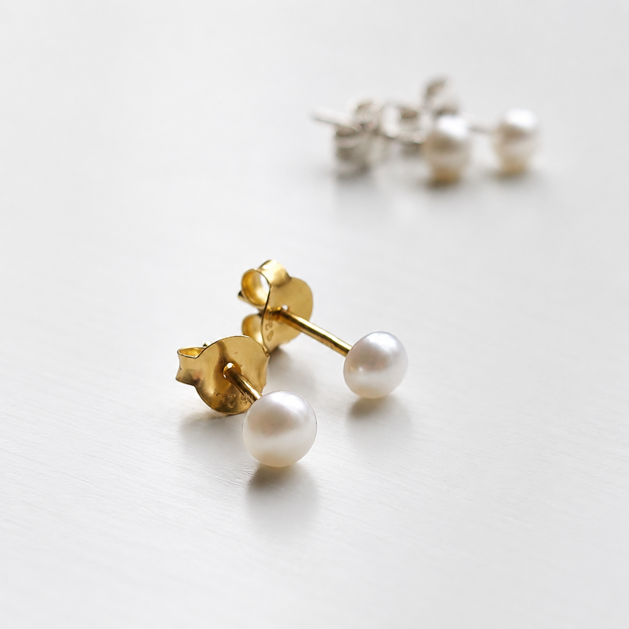 Golden Tiny Freshwater Pearl Studs in Sterling Silver - 4mm